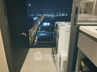 Chic urban balcony with city view and modern washing machine setup, perfect for city living.