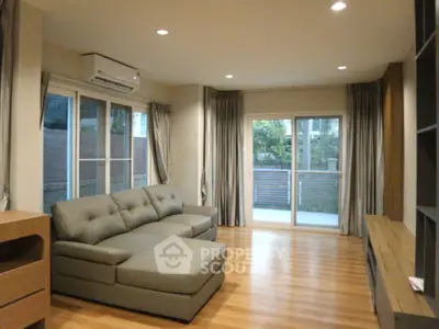 Spacious living room with modern sofa and large windows for natural light