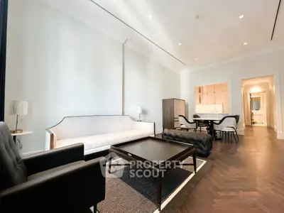 Elegant living room with modern furniture and open layout, featuring a cozy seating area and stylish decor.