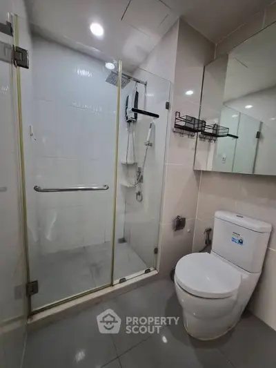 Modern bathroom with glass shower enclosure and sleek fixtures