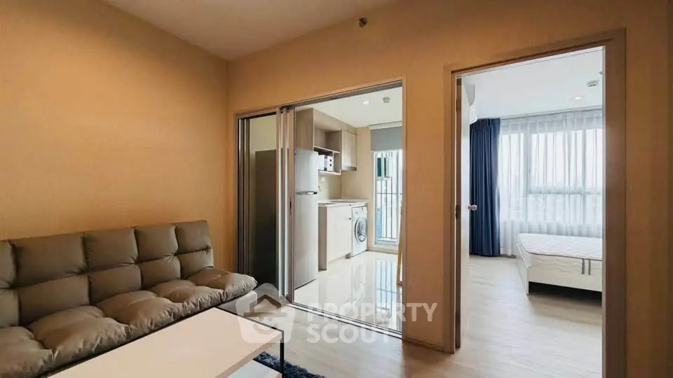 Modern apartment interior with cozy living room, sleek kitchen, and bright bedroom.
