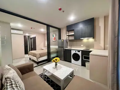Modern studio apartment with open layout, featuring a cozy living area, kitchen, and bedroom.