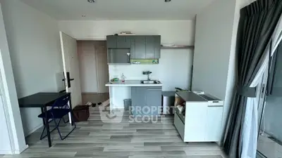 Modern compact kitchen with sleek cabinetry and open layout in a cozy apartment.