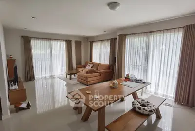 Spacious living room with modern furniture and large windows for natural light.