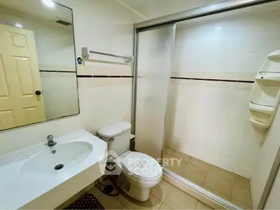 Modern bathroom with sleek fixtures and spacious shower in a contemporary home.