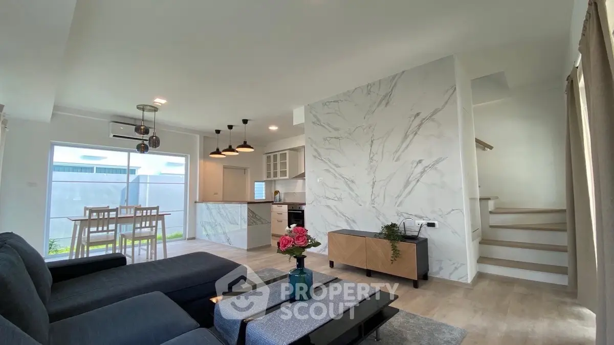 Modern open-plan living room with stylish decor and natural light