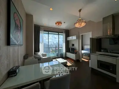 Modern living room with city view, elegant chandelier, and open kitchen layout in a high-rise apartment.