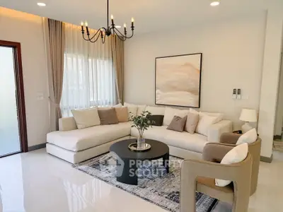 Elegant living room with modern chandelier, cozy sectional sofa, and stylish decor in a bright, inviting space.