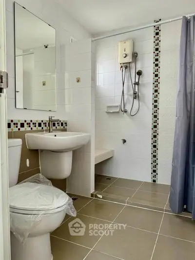 Modern bathroom with shower and stylish tile accents