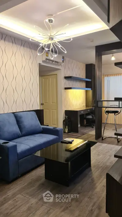 Modern living room with stylish lighting and blue sofa