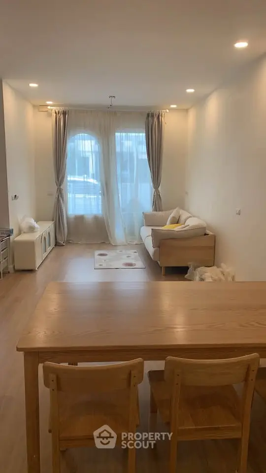 Spacious living room with elegant wooden furniture and soft lighting