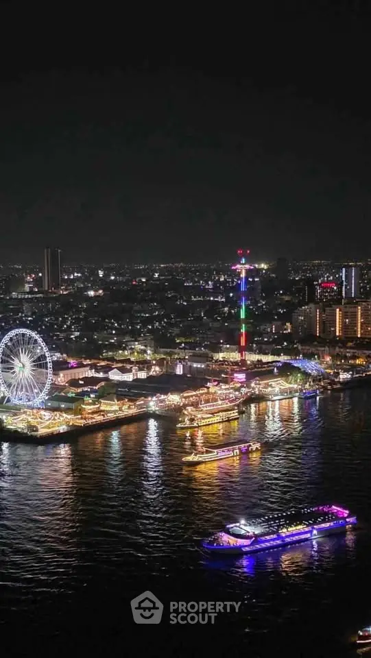 Stunning night view of a vibrant cityscape with illuminated waterfront and ferris wheel.