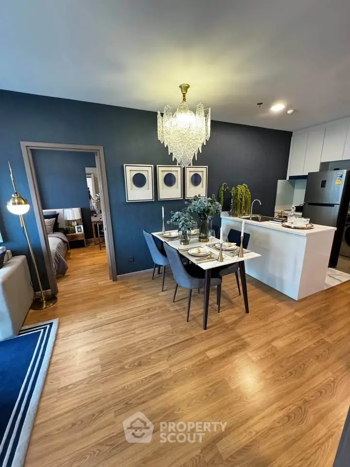 Elegant open-plan living and dining area with modern decor and stylish lighting