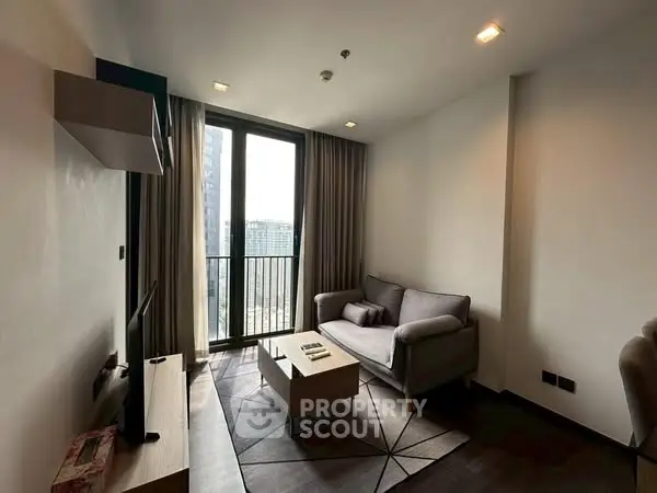 Modern living room with balcony view and stylish furniture in urban apartment.
