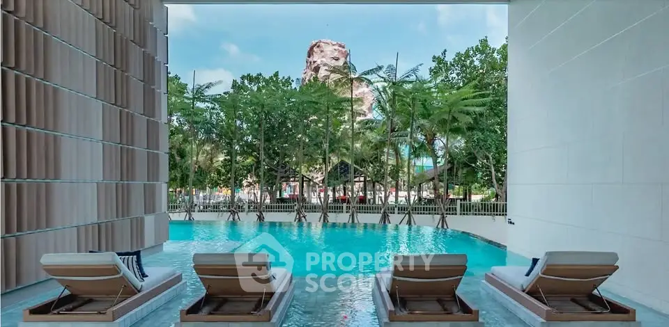 Luxurious poolside view with modern loungers and tropical surroundings, perfect for relaxation and leisure.
