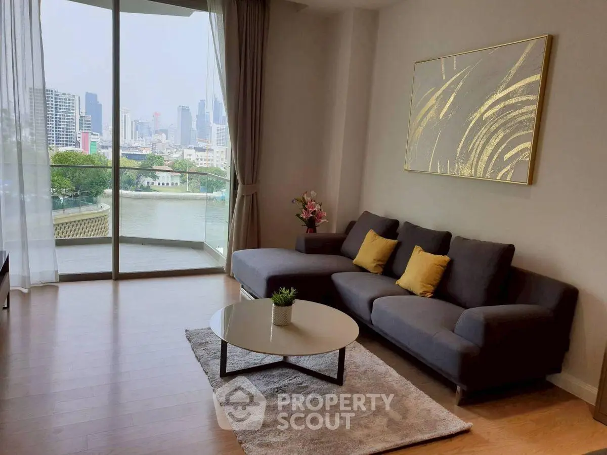 Modern living room with city view, stylish sofa, and elegant decor.