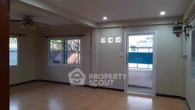 Spacious unfurnished living room with large windows and sliding glass door