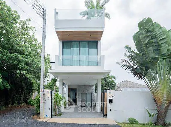 Modern two-story house with sleek design and lush greenery, perfect for contemporary living.