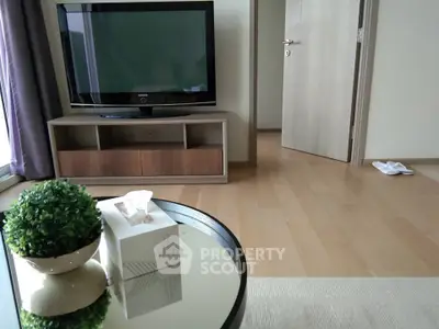 Modern living room with sleek TV stand and wooden flooring, perfect for cozy relaxation.