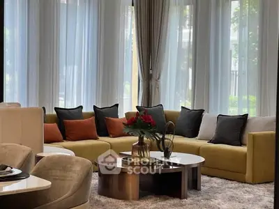 Luxurious living room with elegant decor and large windows offering natural light.