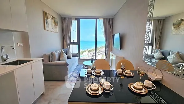 Luxurious living room with ocean view, elegant decor, and modern kitchen in a high-rise apartment.