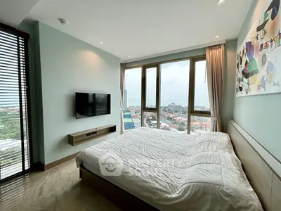 Spacious bedroom with stunning city view and modern decor