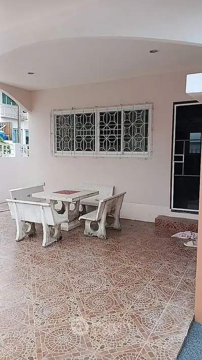 Charming outdoor patio with elegant stone furniture and decorative tiled flooring, perfect for relaxation.