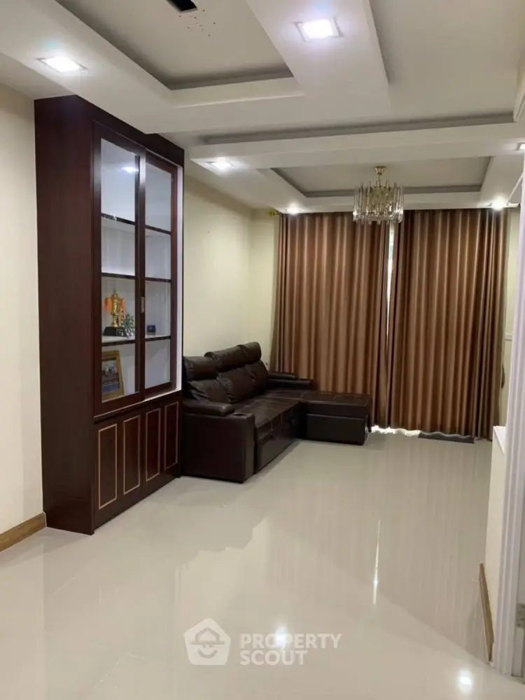 Spacious living room with elegant ceiling design and cozy seating area.