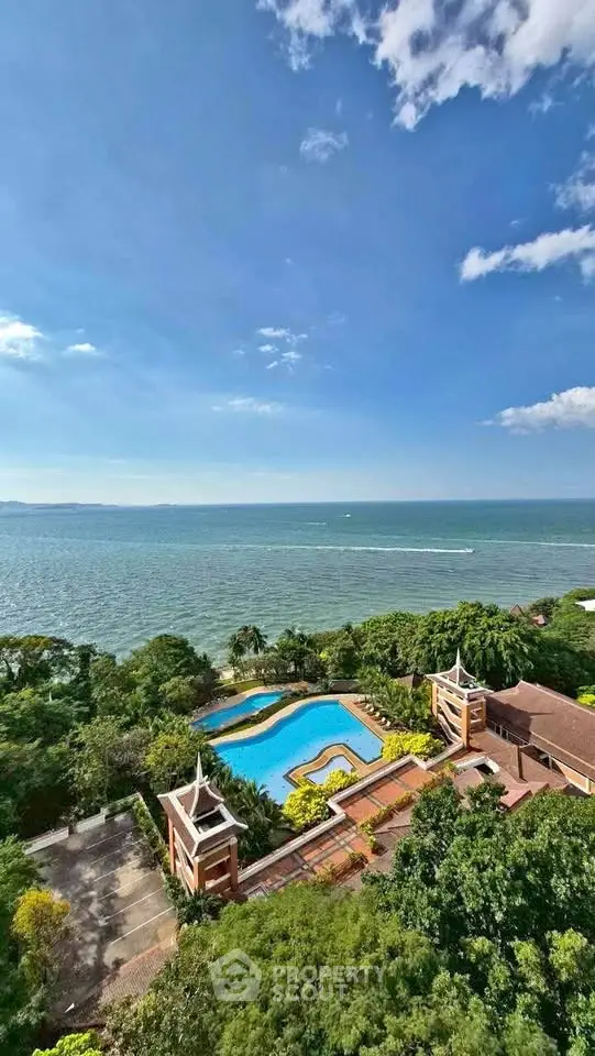 Stunning oceanfront property with pool and lush greenery offering breathtaking sea views.