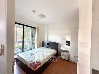 Cozy bedroom with large window and modern furnishings