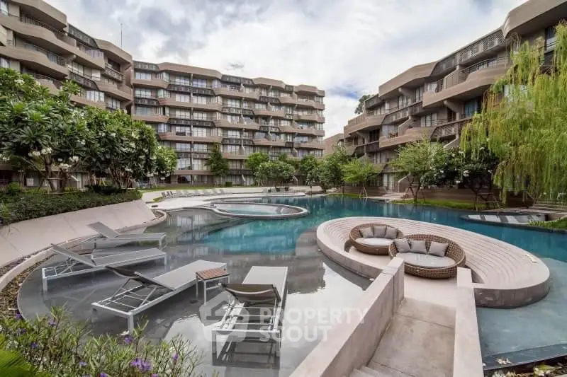 Luxurious modern apartment complex with stunning pool and lush greenery, perfect for relaxation and leisure.