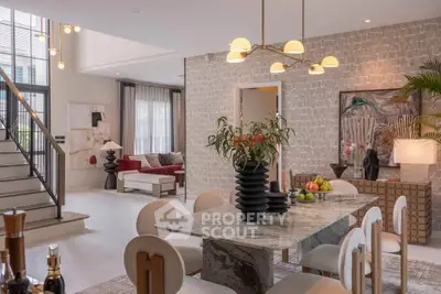 Luxurious open-plan living and dining area with elegant decor and modern furnishings.