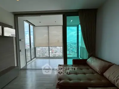 Spacious living room with panoramic city view and large balcony access.