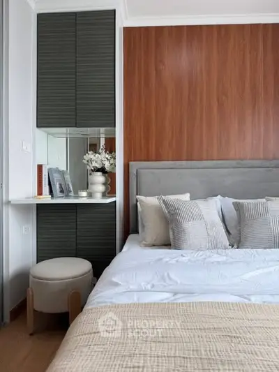 Modern bedroom with stylish decor and cozy bedding in a contemporary apartment.