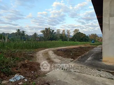 Scenic rural landscape with lush greenery and distant mountains, ideal for tranquil living.