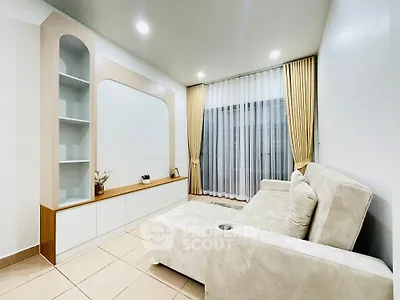 Modern living room with elegant beige sofa and stylish shelving unit