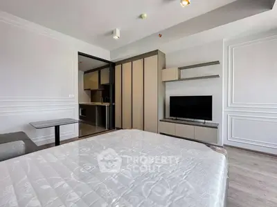 Modern bedroom with sleek design, featuring a built-in wardrobe and flat-screen TV, ideal for urban living.
