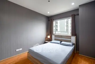 Modern bedroom with minimalist design and large window in urban apartment