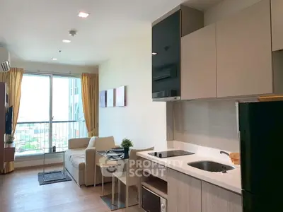 Modern open-plan living room with kitchen, featuring large windows and contemporary decor.