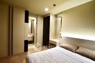 Modern bedroom with sleek design and ample storage space.