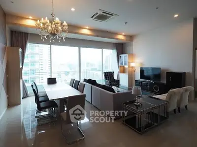 Luxurious modern living room with city view, elegant chandelier, and spacious seating area.