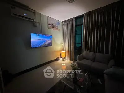 Cozy living room with modern decor, wall-mounted TV, and ambient lighting.