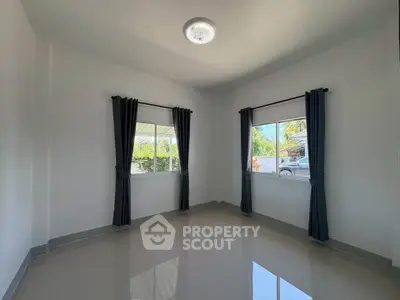 Bright empty room with large windows and glossy tiled floor, perfect for customization.