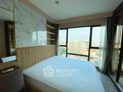Modern bedroom with large windows offering stunning city views in a high-rise apartment.