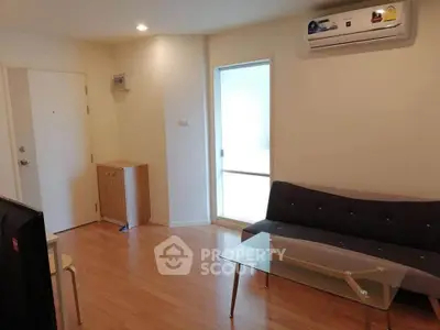 Modern living room with sleek furniture and air conditioning in a cozy apartment.