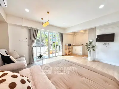 Spacious modern studio with open layout, featuring cozy living area and stylish kitchen, perfect for urban living.