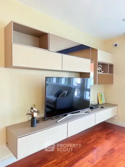 Modern living room with sleek wall-mounted TV and stylish cabinetry.