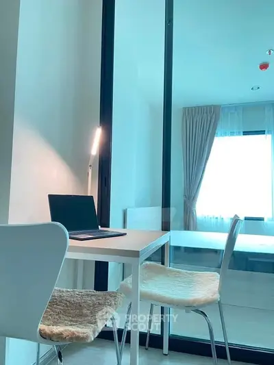 Modern study area with sleek desk and chairs in bright apartment