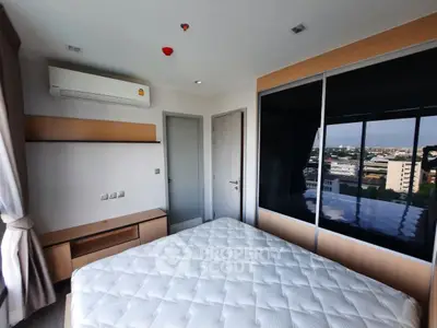 Modern bedroom with large window offering city view, featuring air conditioning and stylish furnishings.