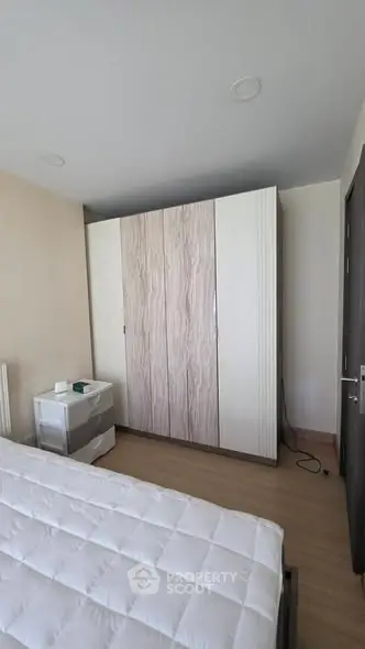 Spacious bedroom with modern wardrobe and cozy bed in a stylish apartment.